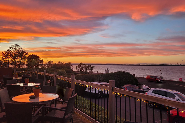 Take in the stunning sunset from the outdoor terrace at the New Holmwood Hotel