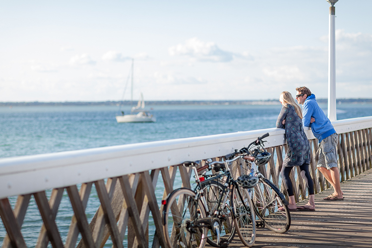 Couple enjoying the sea view from Yarmouth Pier on the Isle of Wight