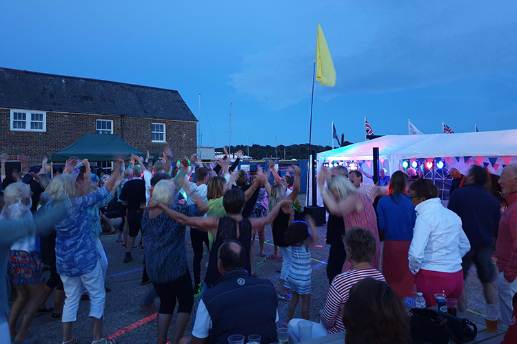 Live music at Rock the Boat event with crowds enjoying the performance at Duver Marina