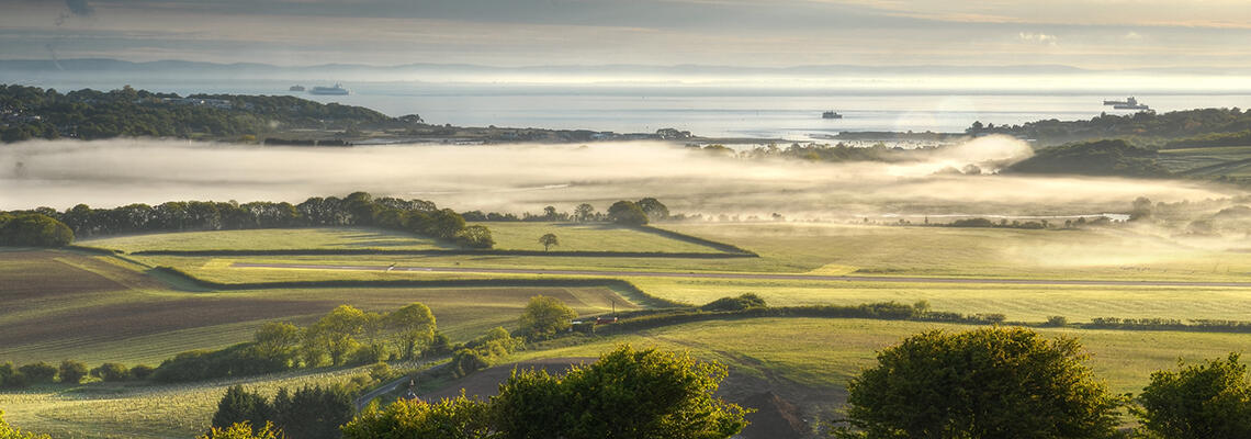 View of Bembridge on the Isle of Wight, showing fields and coast.